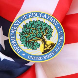 picture of Dept of Education seal lying on top of an American flag