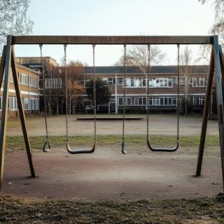 empty swingset in empty schoolyard