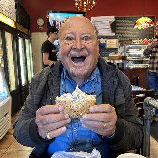 David Berliner happily holding a bagel