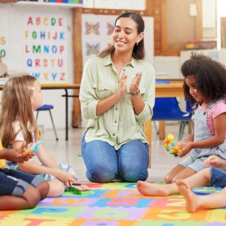 picture of teacher with preschool students in classroom