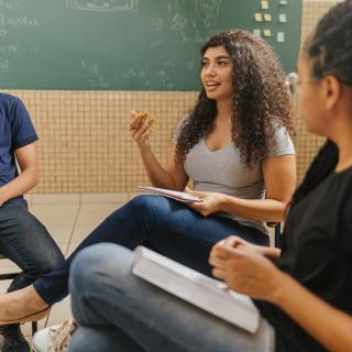 three hispanic students in classroom