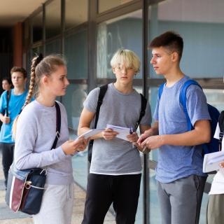 students talking in a school hallway