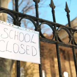 picture hanging on school fence saying "school closed"